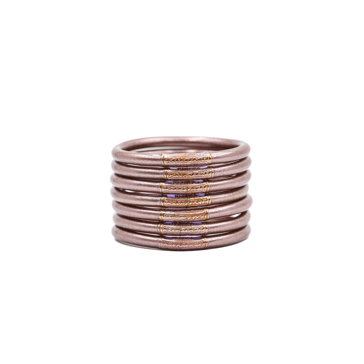 Pila de pulseras lisas en tonos rosa y malva.